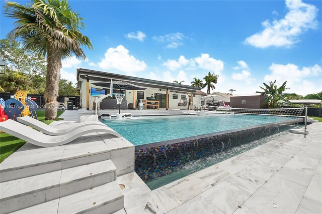 8840 SW 181st Ter, Palmetto Bay, FL 33157 - view of swimming pool featuring a patio area, fence, an infinity pool, and ceiling fan