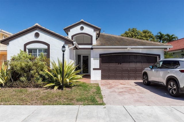 15763 SW 82nd St, Miami, FL 33193 - ranch-style house featuring a garage, stucco siding, driveway, and a tile roof