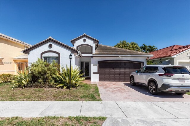 15763 SW 82nd St, Miami, FL 33193 - ranch-style home featuring a garage, concrete driveway, and stucco siding