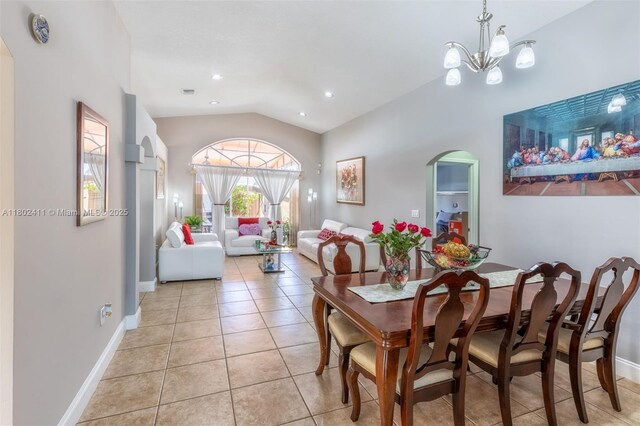 15763 SW 82nd St, Miami, FL 33193 - dining room with arched walkways, vaulted ceiling, light tile patterned floors, baseboards, and a chandelier