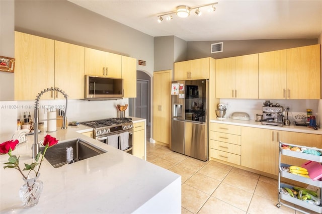 15763 SW 82nd St, Miami, FL 33193 - kitchen featuring stainless steel appliances, light brown cabinets, vaulted ceiling, light countertops, and light tile patterned floors