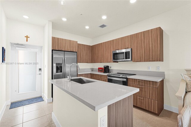 8301 NW 41st St Unit B-303, Doral, FL 33166 - kitchen with stainless steel appliances, modern cabinets, brown cabinetry, light countertops, and recessed lighting