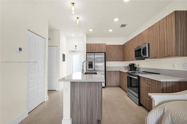8301 NW 41st St Unit B-303, Doral, FL 33166 - kitchen with stainless steel appliances, modern cabinets, an island with sink, light tile patterned floors, and recessed lighting