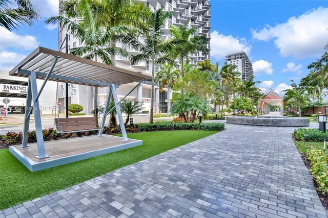 8301 NW 41st St Unit B-303, Doral, FL 33166 - view of community with a pergola and a lawn