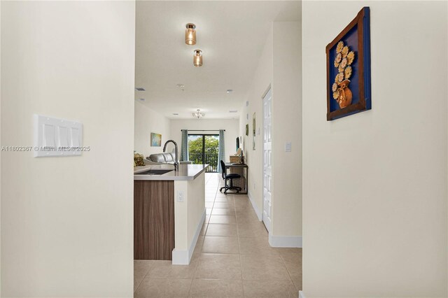 8301 NW 41st St Unit B-303, Doral, FL 33166 - hall featuring light tile patterned floors, a sink, and baseboards