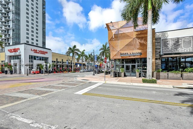 8301 NW 41st St Unit B-303, Doral, FL 33166 - view of asphalt street featuring sidewalks, street lights, curbs, and traffic signs