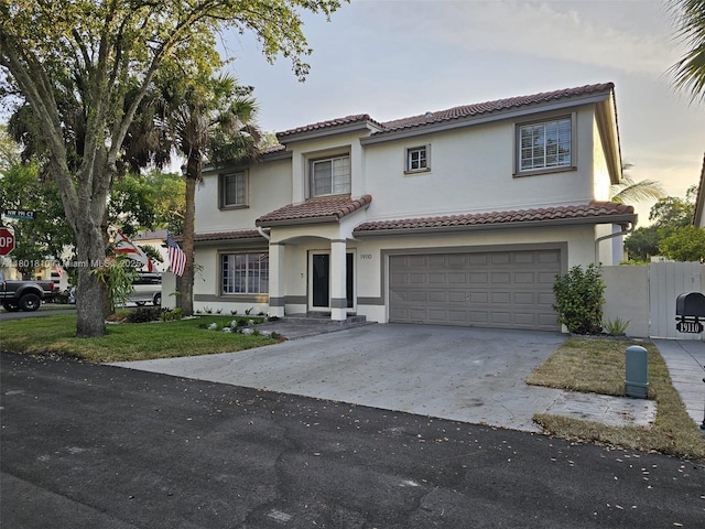 19110 NW 88th Ct, Hialeah, FL 33018 - mediterranean / spanish home featuring a tiled roof, stucco siding, concrete driveway, and an attached garage