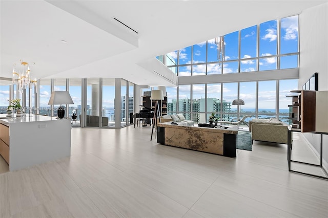851 NE 1st Ave Ph 5401, Miami, FL 33132 - living area featuring a chandelier, healthy amount of natural light, expansive windows, a view of city, and a water view