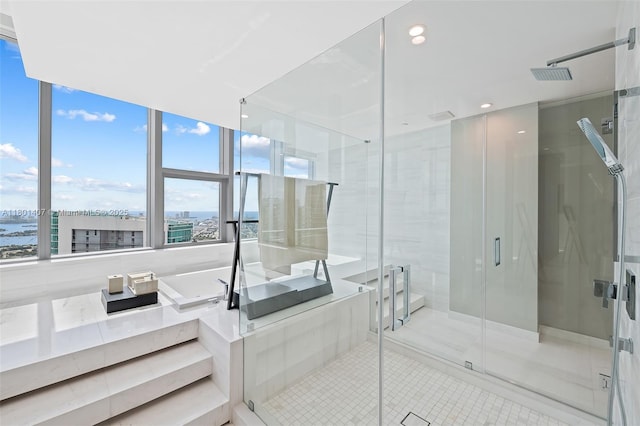 851 NE 1st Ave Ph 5401, Miami, FL 33132 - bathroom with a stall shower, tile patterned floors, a bath, recessed lighting, and a water view