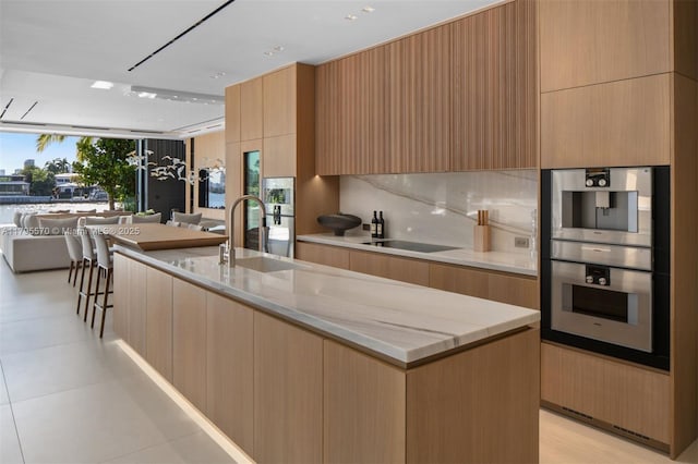 220 W Dilido Dr, Miami Beach, FL 33139 - kitchen featuring stainless steel double oven, a sink, modern cabinets, and open floor plan