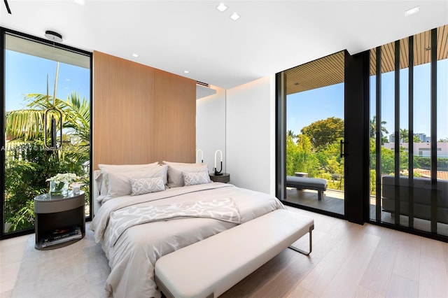220 W Dilido Dr, Miami Beach, FL 33139 - bedroom featuring expansive windows, access to outside, and light wood finished floors