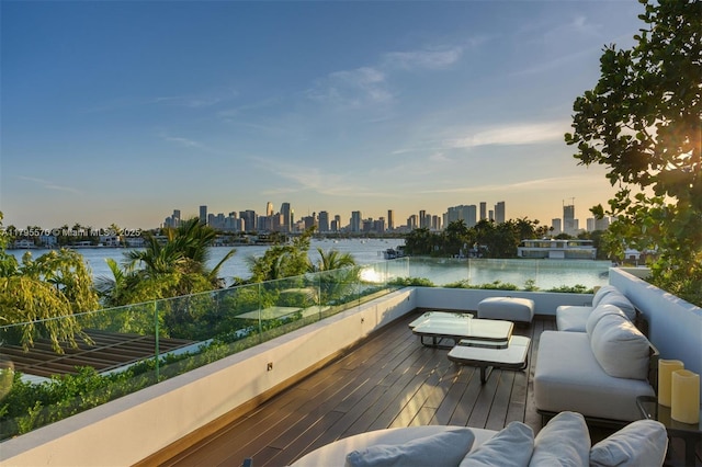 220 W Dilido Dr, Miami Beach, FL 33139 - deck at dusk with a skyline view, outdoor lounge area, and a water view