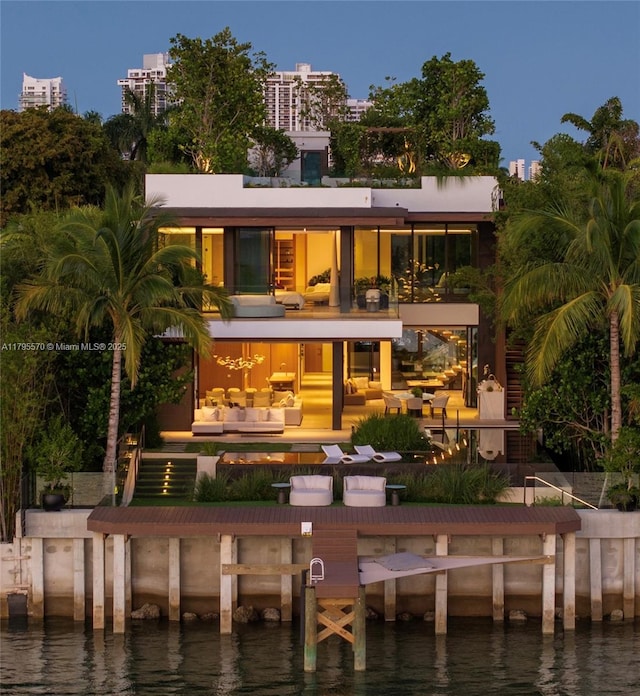 220 W Dilido Dr, Miami Beach, FL 33139 - rear view of house featuring an outdoor hangout area, a water view, a balcony, and a patio area