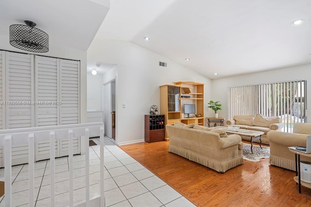 living room featuring vaulted ceiling, recessed lighting, light tile patterned floors, and baseboards