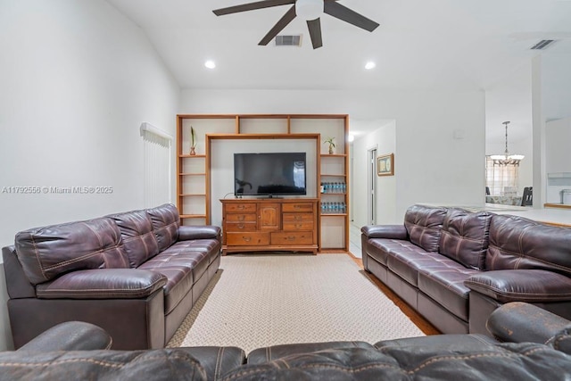 living room with ceiling fan, a chandelier, lofted ceiling, and recessed lighting