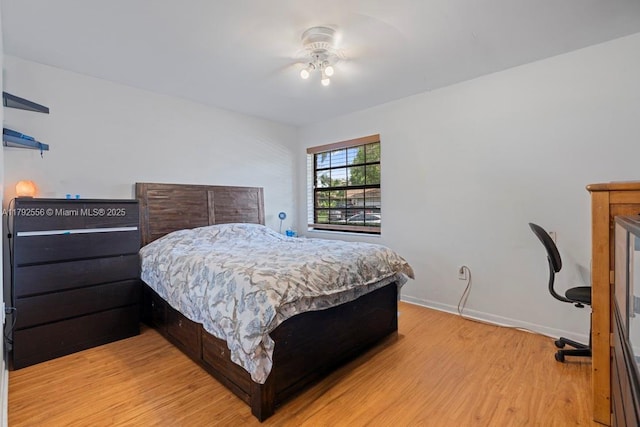 bedroom with light wood-style flooring and baseboards