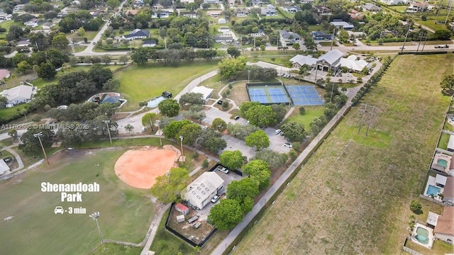 aerial view of property and surrounding area featuring nearby suburban area