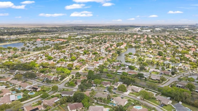 aerial view of property's location with a nearby body of water and nearby suburban area