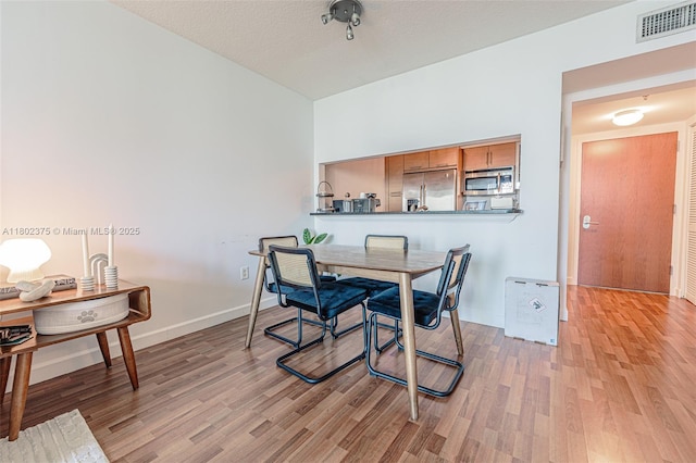 31 SE 5th St Unit 1603, Miami, FL 33131 - dining space with light wood-style flooring and baseboards