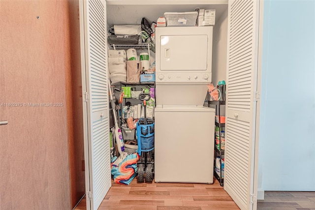 31 SE 5th St Unit 1603, Miami, FL 33131 - clothes washing area featuring estacked washer and dryer and wood finished floors