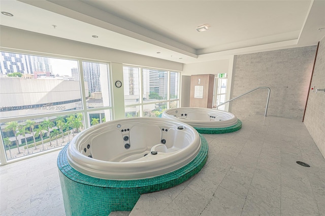 31 SE 5th St Unit 1603, Miami, FL 33131 - full bath featuring a whirlpool tub, plenty of natural light, and a tray ceiling