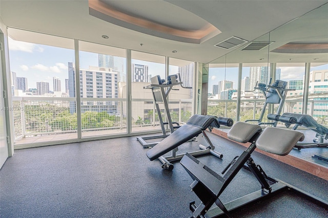 31 SE 5th St Unit 1603, Miami, FL 33131 - exercise room with a skyline view, a raised ceiling, and expansive windows