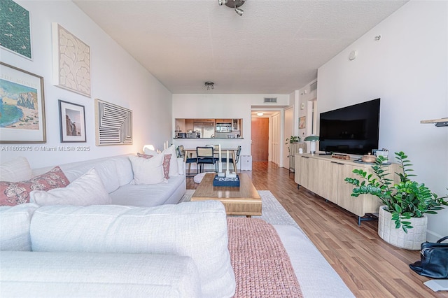 31 SE 5th St Unit 1603, Miami, FL 33131 - living room featuring wood finished floors and a textured ceiling