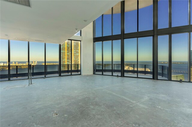 1000 Brickell Plz Unit Uph6201, Miami, FL 33131 - unfurnished room with a water view, expansive windows, and a towering ceiling