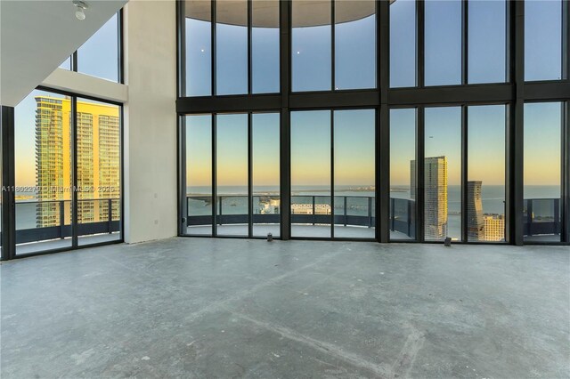 1000 Brickell Plz Unit Uph6201, Miami, FL 33131 - unfurnished living room featuring a high ceiling and a water view