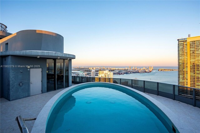 1000 Brickell Plz Unit Uph6201, Miami, FL 33131 - pool at dusk with a water view