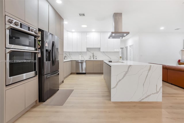 5530 SW 195th Ter, Southwest Ranches, FL 33332 - kitchen with appliances with stainless steel finishes, modern cabinets, island exhaust hood, a sink, and light wood finished floors