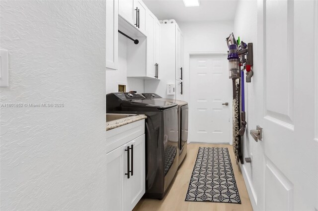 5530 SW 195th Ter, Southwest Ranches, FL 33332 - washroom featuring washing machine and clothes dryer, cabinet space, and light wood-style floors