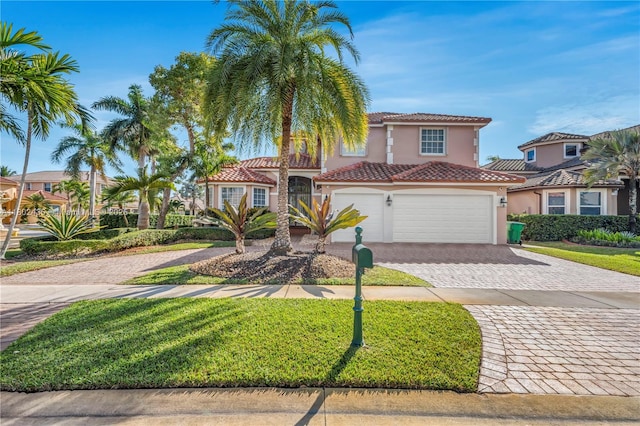18900 SW 32nd Ct, Miramar, FL 33029 - mediterranean / spanish-style house with decorative driveway, stucco siding, a tile roof, a garage, and a front yard