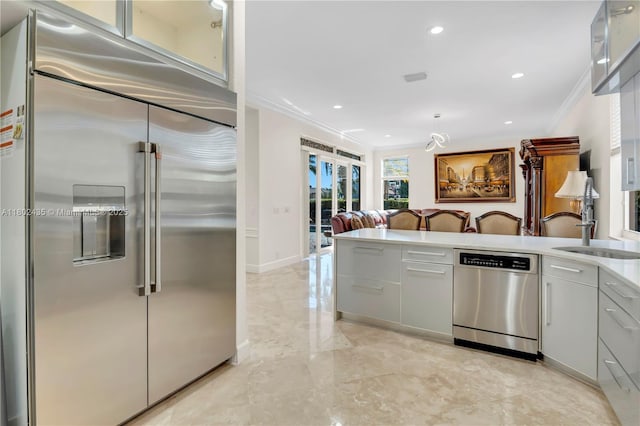 18900 SW 32nd Ct, Miramar, FL 33029 - kitchen with appliances with stainless steel finishes, ornamental molding, modern cabinets, light countertops, and light marble finish flooring