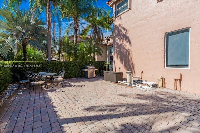 18900 SW 32nd Ct, Miramar, FL 33029 - view of patio featuring fence, grilling area, and outdoor dining area