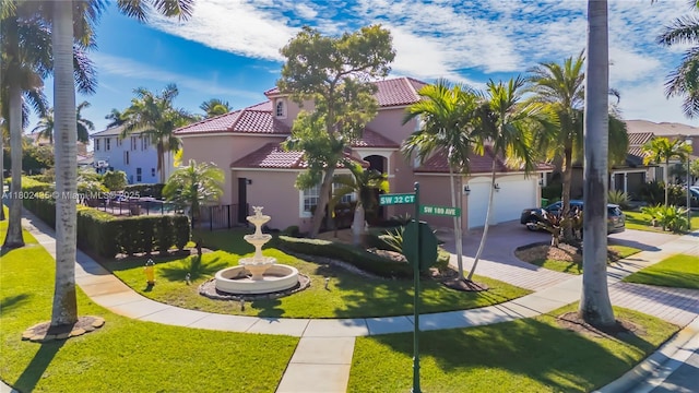 18900 SW 32nd Ct, Miramar, FL 33029 - mediterranean / spanish home featuring a tiled roof, stucco siding, driveway, a front lawn, and an attached garage