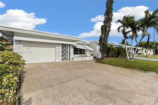 5706 NW 81st Ave, Tamarac, FL 33321 - view of property exterior with a garage, a tile roof, a lawn, and driveway