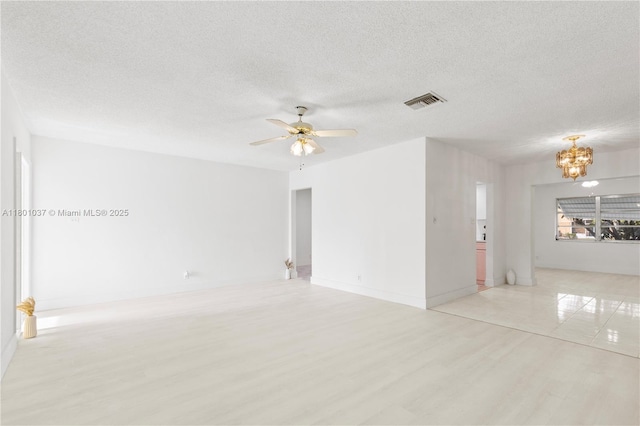 5706 NW 81st Ave, Tamarac, FL 33321 - empty room featuring a chandelier, light wood-style floors, ceiling fan, a textured ceiling, and baseboards
