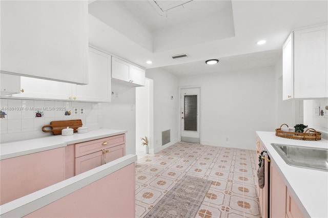 5706 NW 81st Ave, Tamarac, FL 33321 - kitchen featuring a sink, light countertops, white cabinetry, backsplash, and recessed lighting