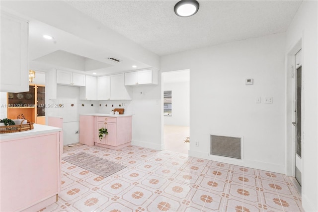 5706 NW 81st Ave, Tamarac, FL 33321 - kitchen with white cabinetry and a textured ceiling