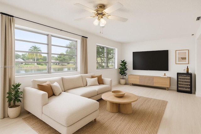 5706 NW 81st Ave, Tamarac, FL 33321 - living room with wine cooler, a ceiling fan, a water view, wood finished floors, and baseboards