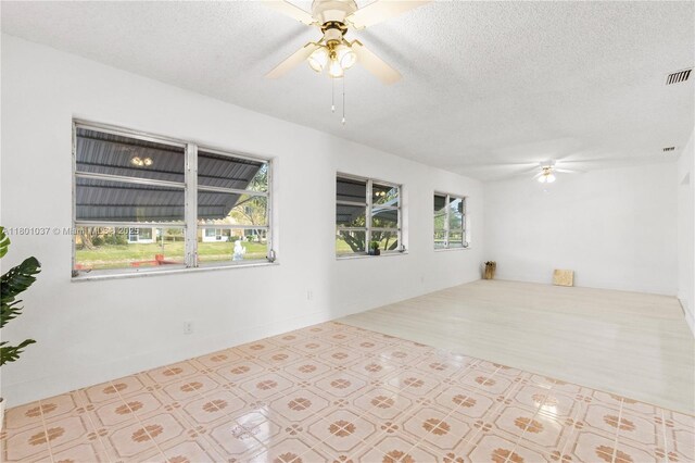 5706 NW 81st Ave, Tamarac, FL 33321 - unfurnished room with ceiling fan, plenty of natural light, and a textured ceiling