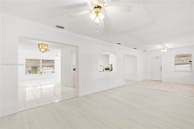 5706 NW 81st Ave, Tamarac, FL 33321 - unfurnished room featuring ceiling fan, a chandelier, a textured ceiling, and wood finished floors
