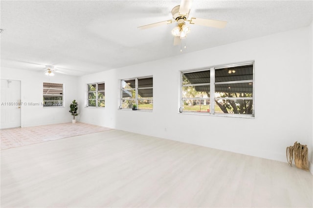 5706 NW 81st Ave, Tamarac, FL 33321 - spare room featuring a ceiling fan, wood finished floors, plenty of natural light, and a textured ceiling