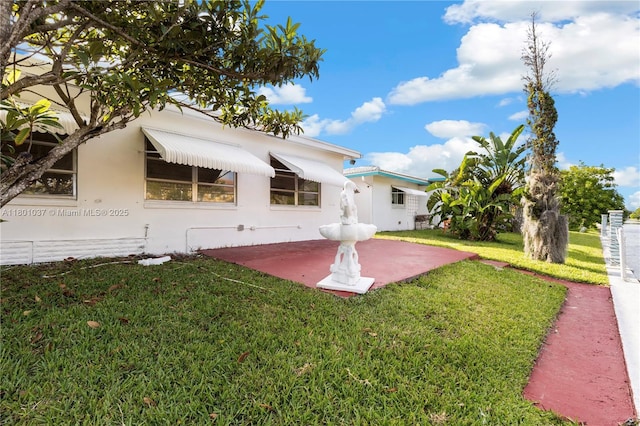 5706 NW 81st Ave, Tamarac, FL 33321 - rear view of property featuring a lawn and stucco siding