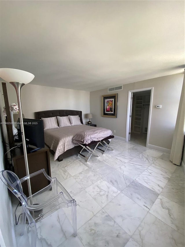 bedroom with light marble finish floors and baseboards