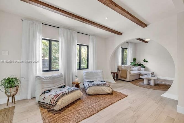 4228 NW 3rd Ave, Miami, FL 33127 - sitting room with arched walkways, beam ceiling, light wood-style floors, and baseboards