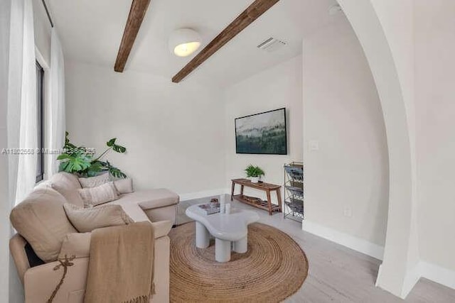 4228 NW 3rd Ave, Miami, FL 33127 - living room featuring arched walkways, beamed ceiling, and baseboards
