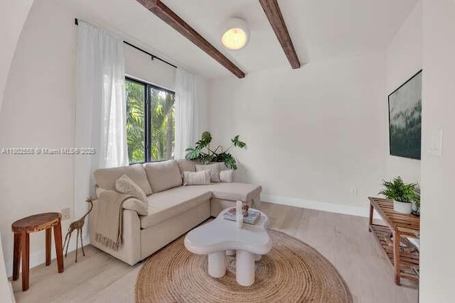 4228 NW 3rd Ave, Miami, FL 33127 - living room featuring beam ceiling, light wood finished floors, and baseboards
