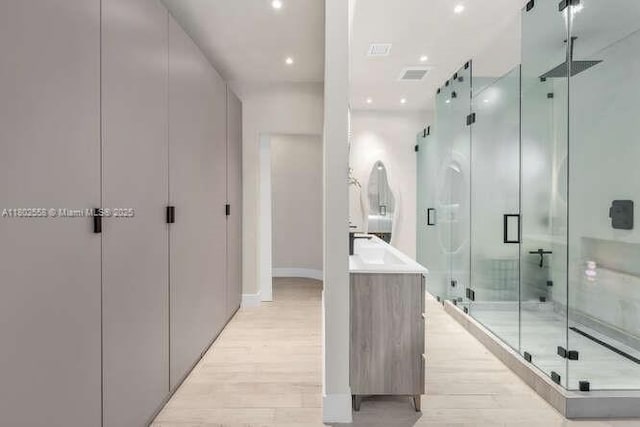 4228 NW 3rd Ave, Miami, FL 33127 - full bathroom featuring a stall shower, wood finished floors, vanity, recessed lighting, and baseboards